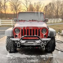 Red Jeep during an exterior wash